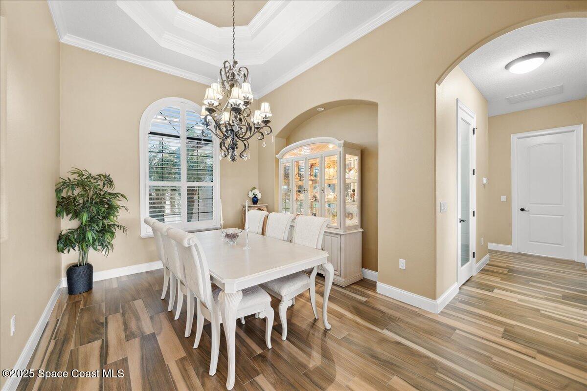 4464 Preservation Circle Melbourne, FL 32934 - Photo 18 of 65 a view of a dining room with furniture window and wooden floor