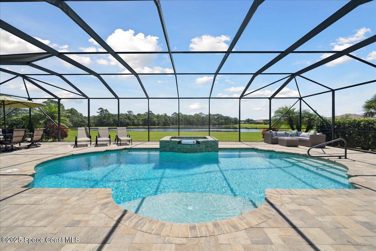 4464 Preservation Circle Melbourne, FL 32934 - Photo 2 of 65 a view of a swimming pool with a couches in patio