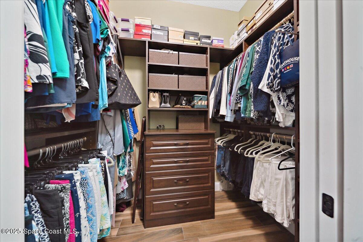 4464 Preservation Circle Melbourne, FL 32934 - Photo 25 of 65 a view of walk in closet with clothes and shoes