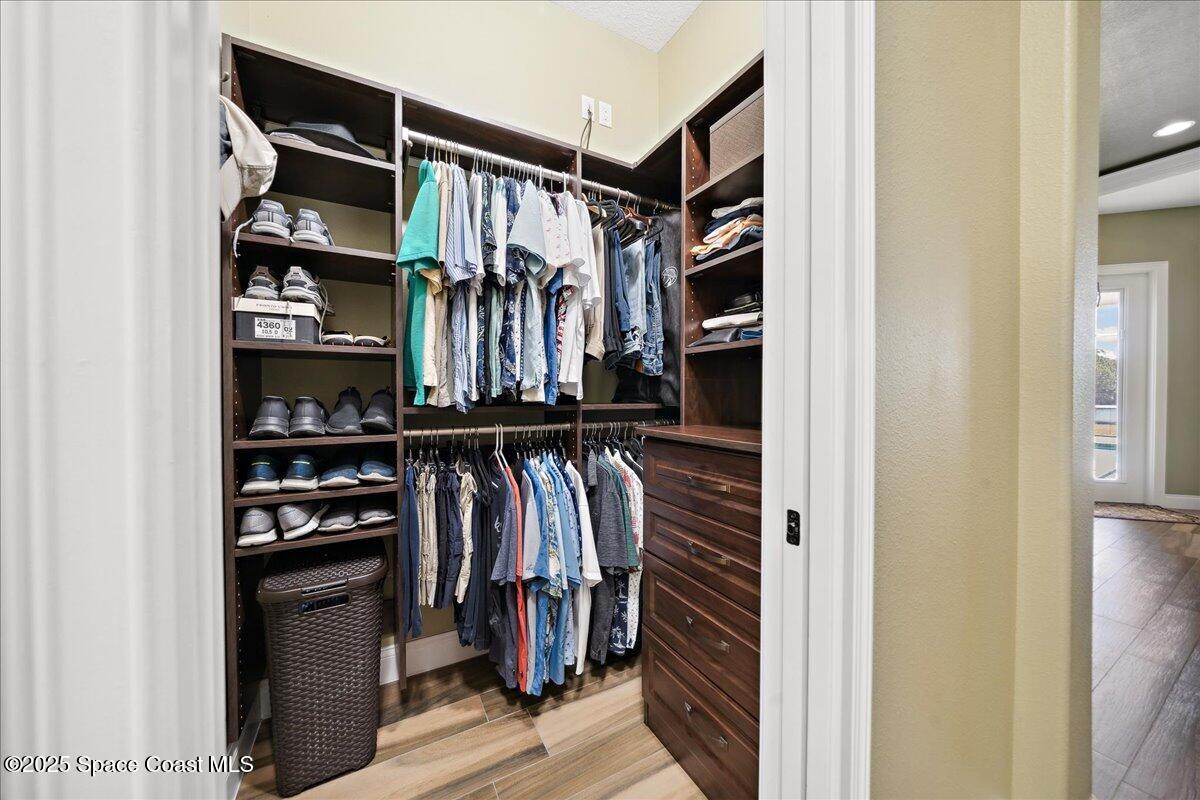 4464 Preservation Circle Melbourne, FL 32934 - Photo 26 of 65 a view of walk in closet with clothes and shoes