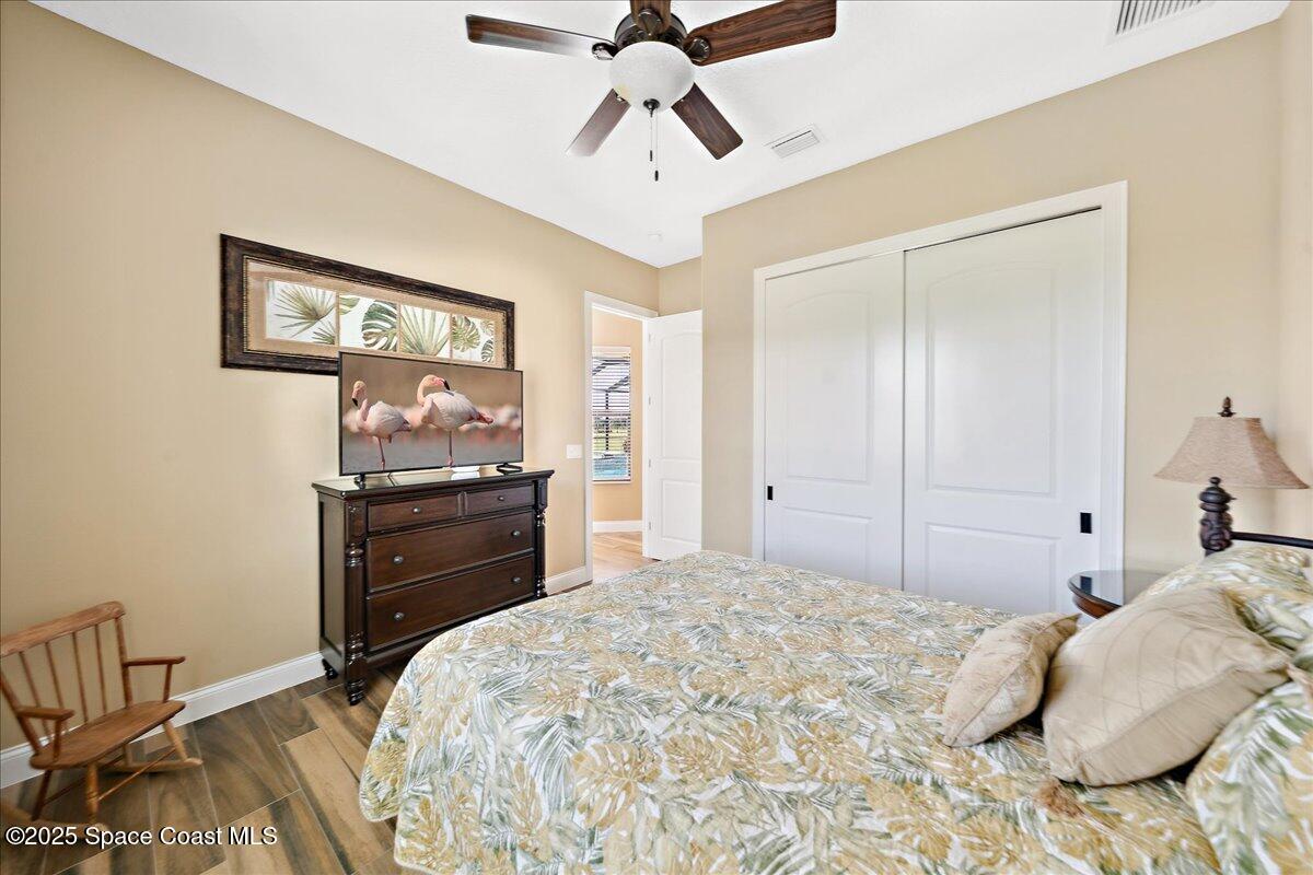 4464 Preservation Circle Melbourne, FL 32934 - Photo 30 of 65 a bedroom with a bed and a chandelier