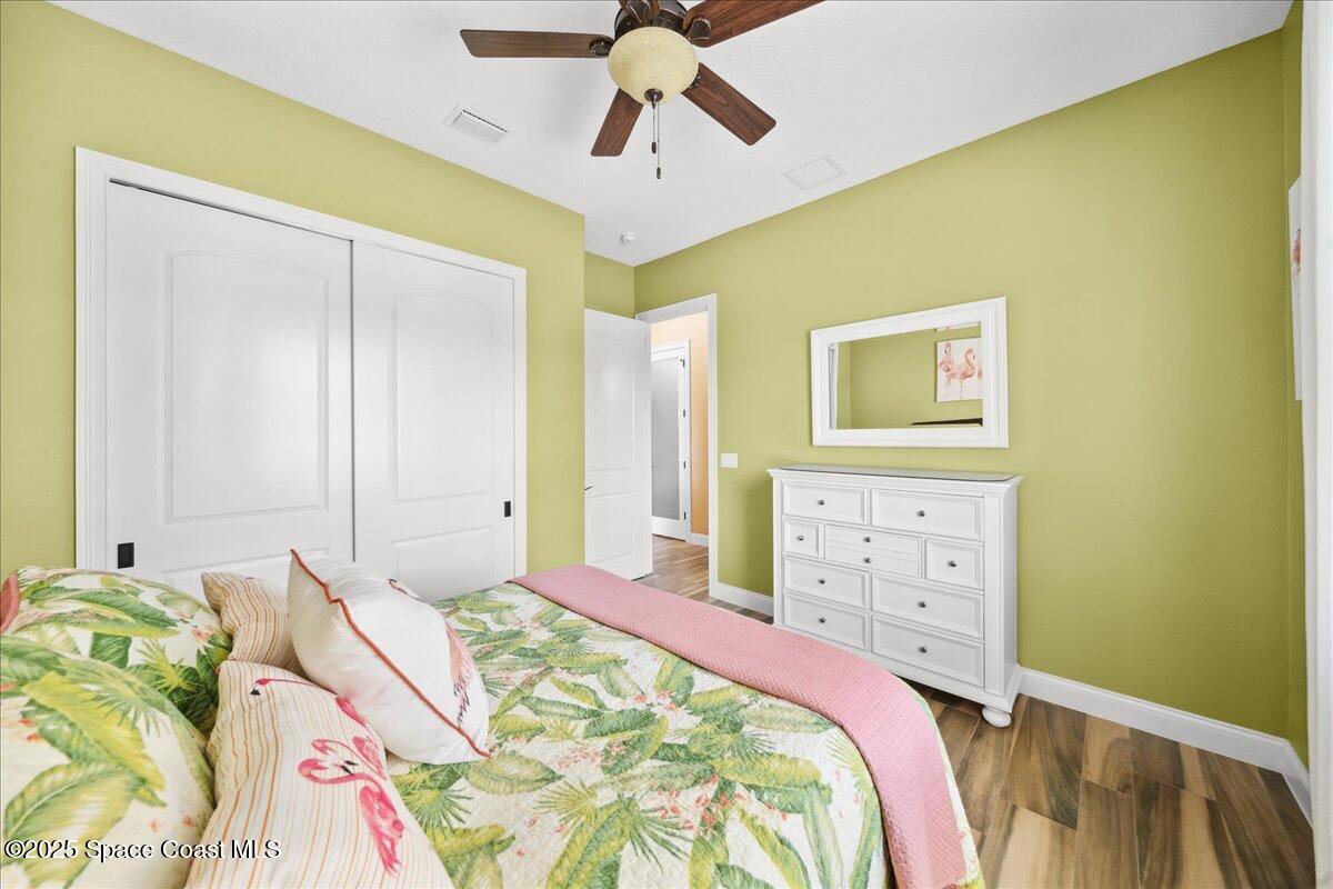 4464 Preservation Circle Melbourne, FL 32934 - Photo 34 of 65 a bedroom with a bed and a chandelier