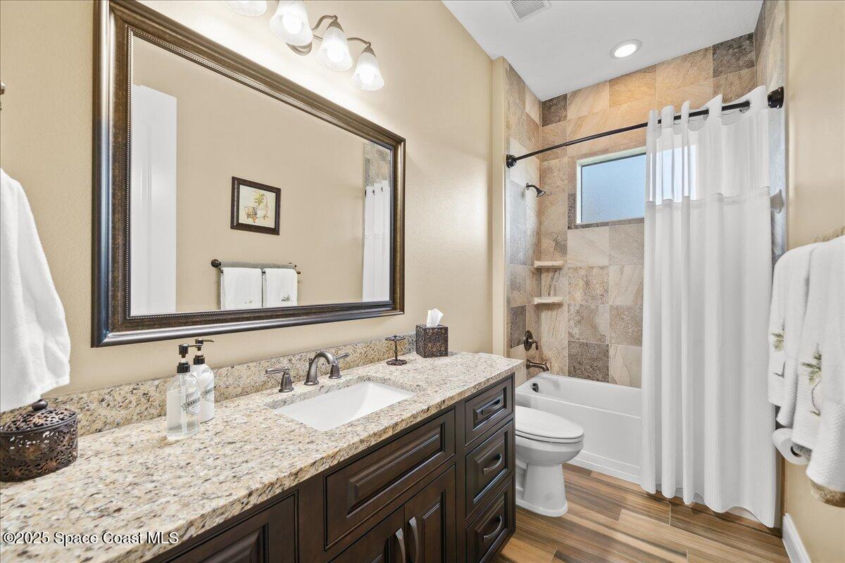4464 Preservation Circle Melbourne, FL 32934 - Photo 35 of 65 a bathroom with a granite countertop sink toilet and shower