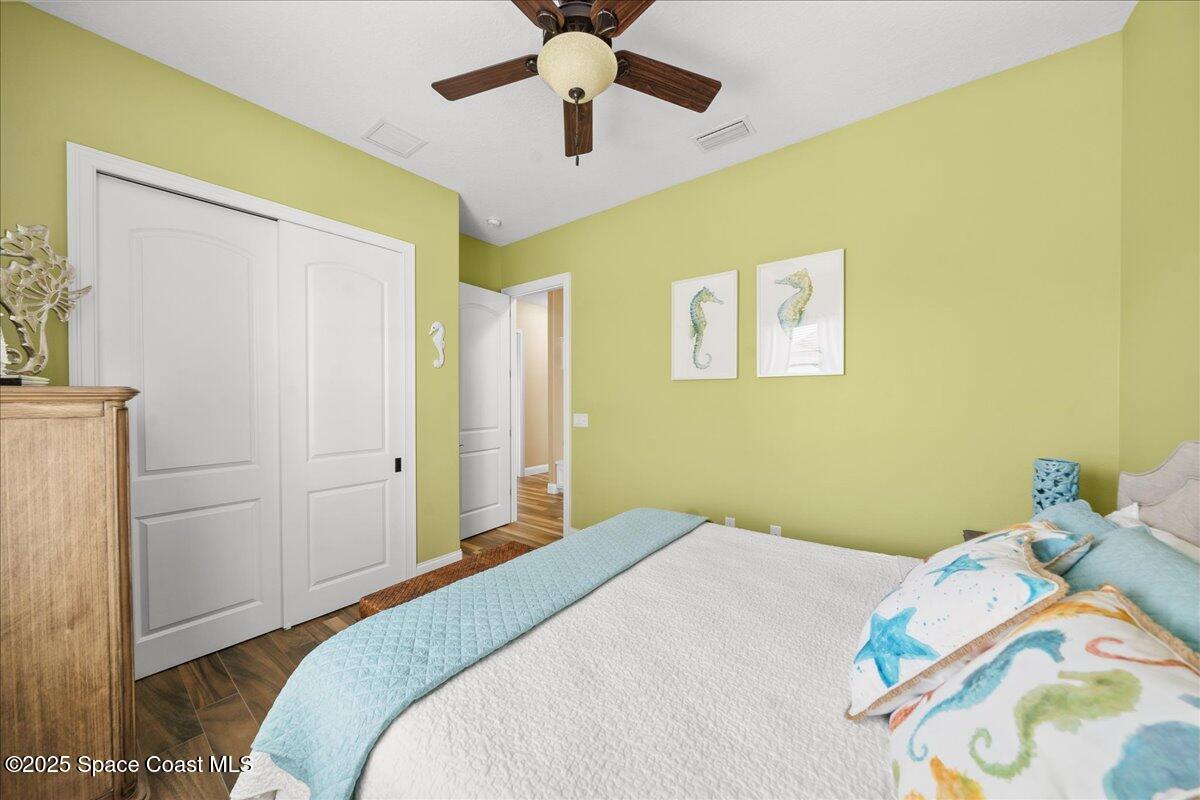 4464 Preservation Circle Melbourne, FL 32934 - Photo 38 of 65 a bedroom with a bed and a chandelier