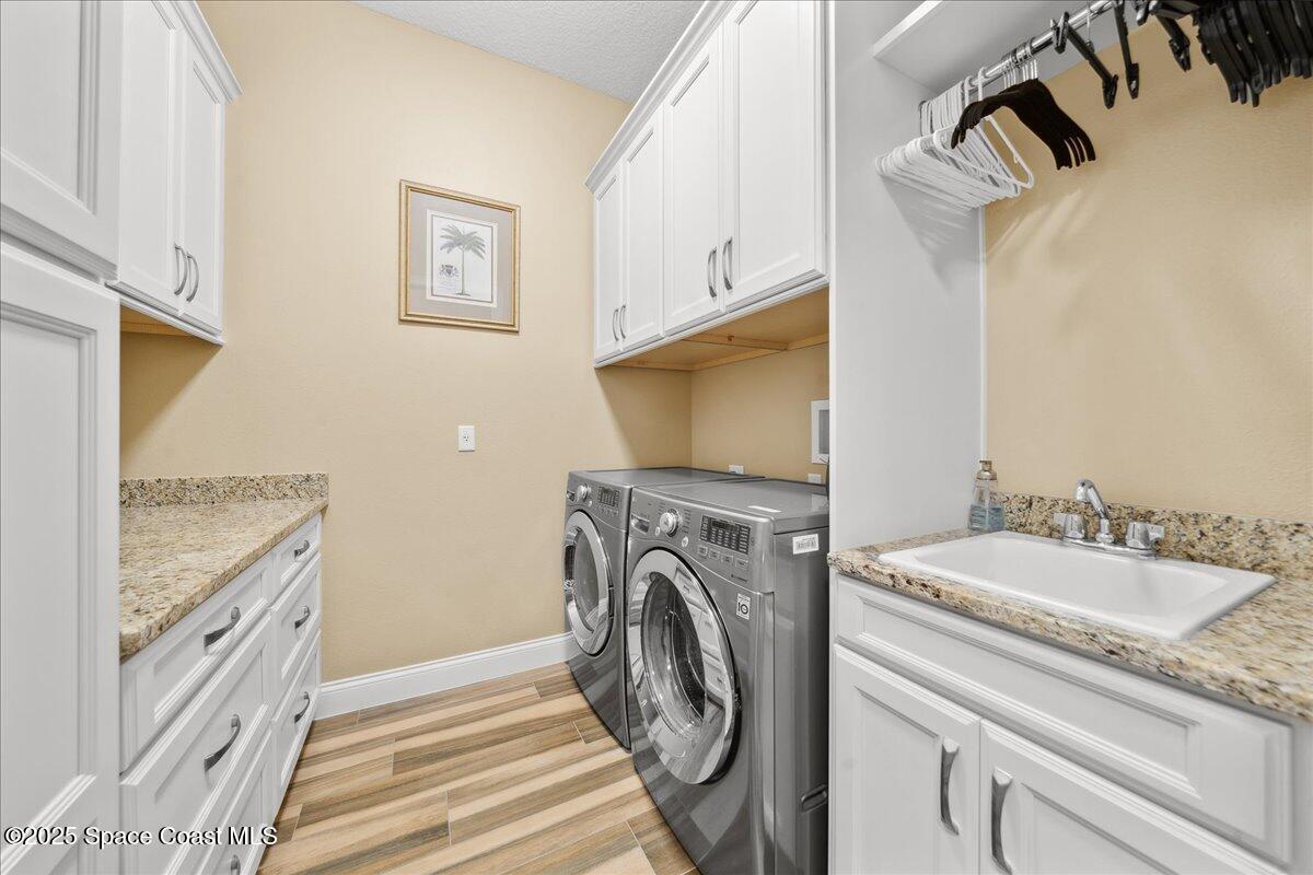 4464 Preservation Circle Melbourne, FL 32934 - Photo 39 of 65 a view of a kitchen with washer and dryer