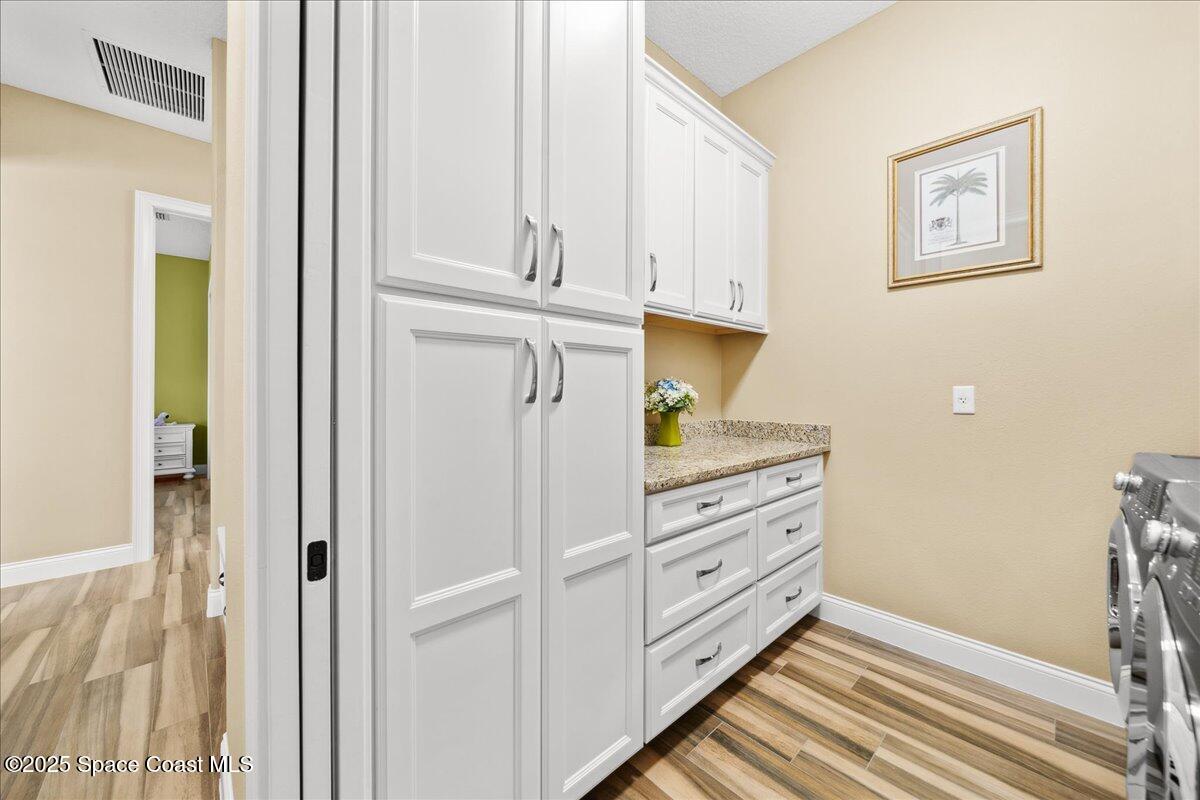4464 Preservation Circle Melbourne, FL 32934 - Photo 40 of 65 a kitchen with stainless steel appliances cabinets and a window