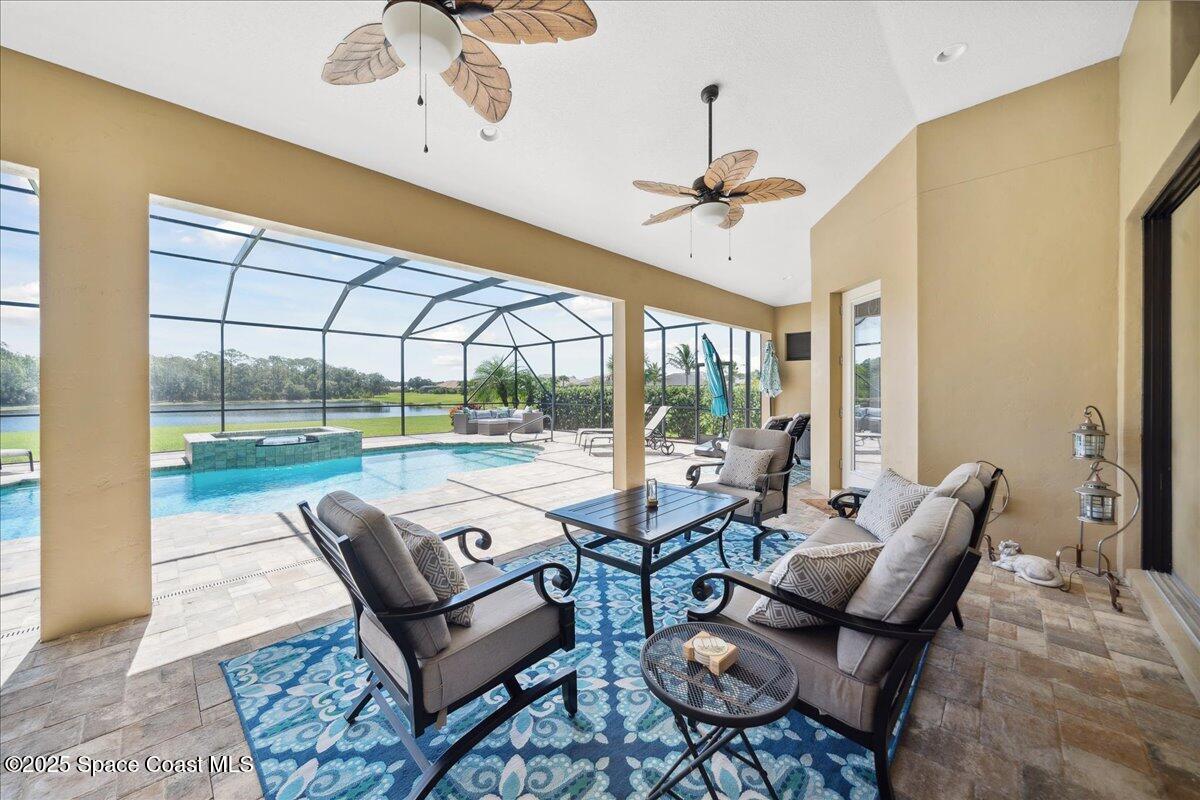 4464 Preservation Circle Melbourne, FL 32934 - Photo 43 of 65 a living room with furniture and a floor to ceiling window
