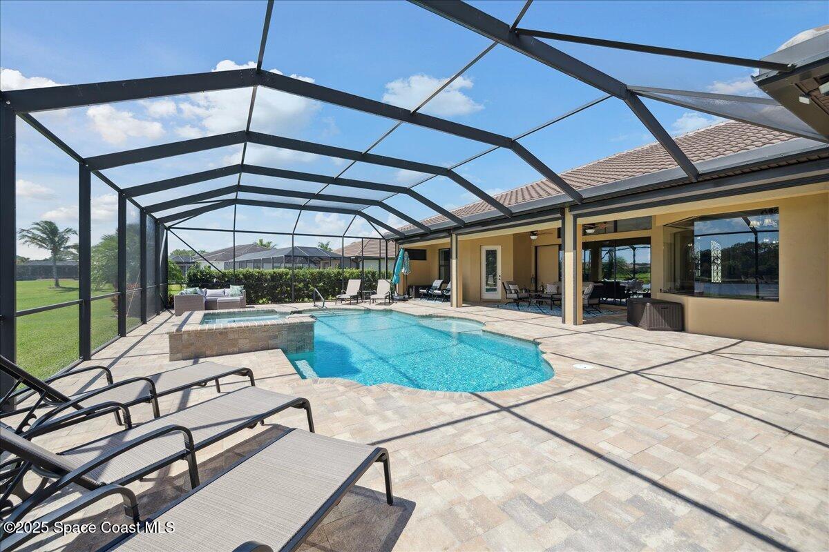 4464 Preservation Circle Melbourne, FL 32934 - Photo 44 of 65 a view of a patio with a table and chairs under an umbrella