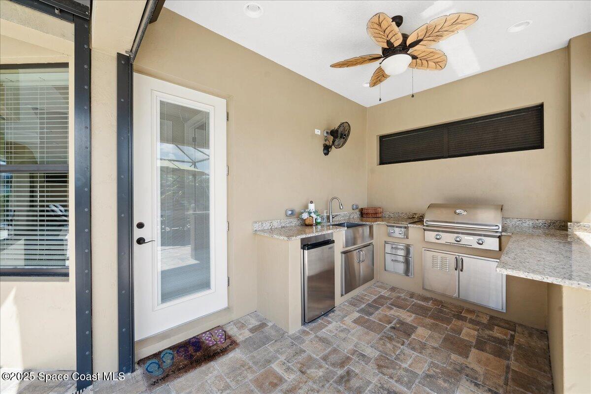 4464 Preservation Circle Melbourne, FL 32934 - Photo 48 of 65 a kitchen with a stove a refrigerator and a sink