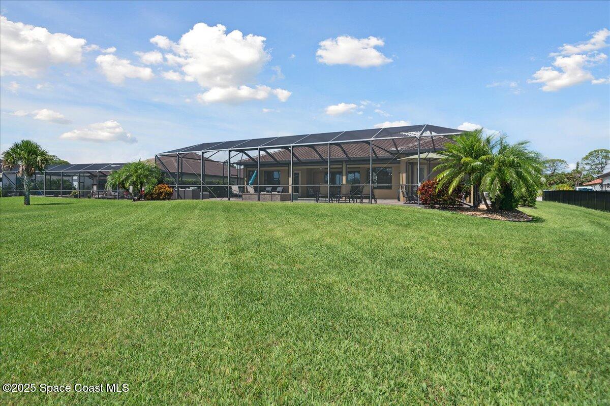4464 Preservation Circle Melbourne, FL 32934 - Photo 51 of 65 a view of a backyard with plants and a garden