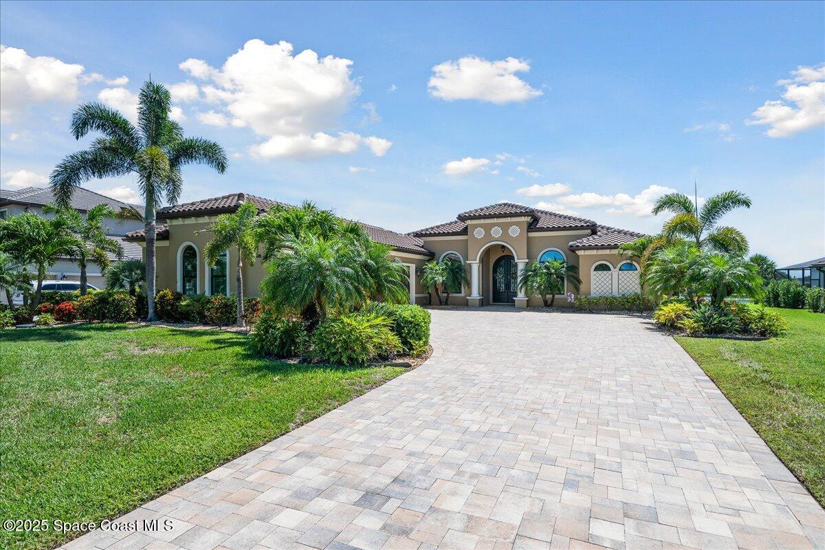 4464 Preservation Circle Melbourne, FL 32934 - Photo 55 of 65 a front view of a house with a yard and a garden