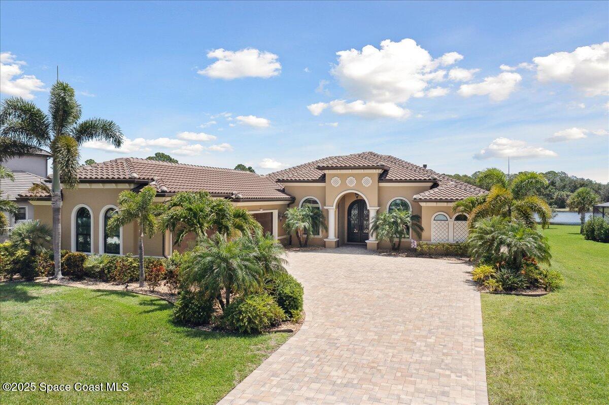 4464 Preservation Circle Melbourne, FL 32934 - Photo 58 of 65 a front view of a house with a garden