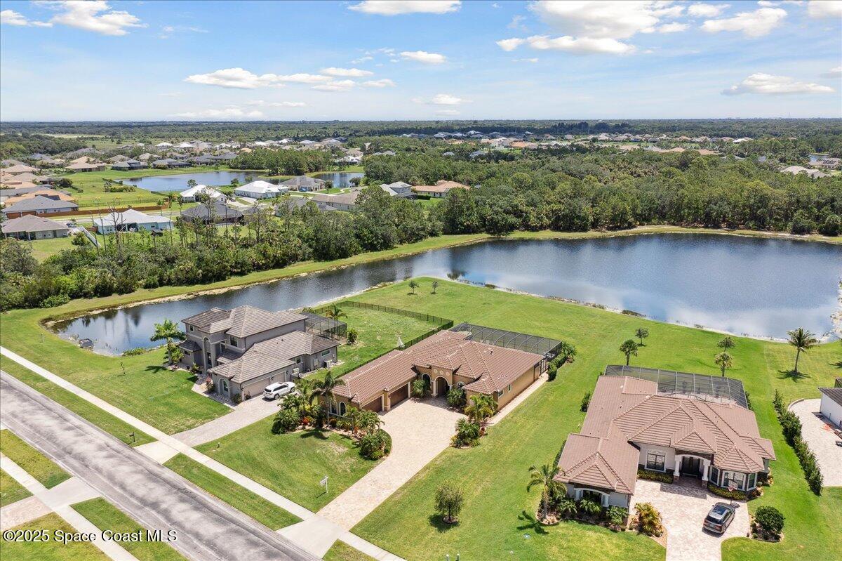 4464 Preservation Circle Melbourne, FL 32934 - Photo 59 of 65 an aerial view of a house with outdoor space and lake view