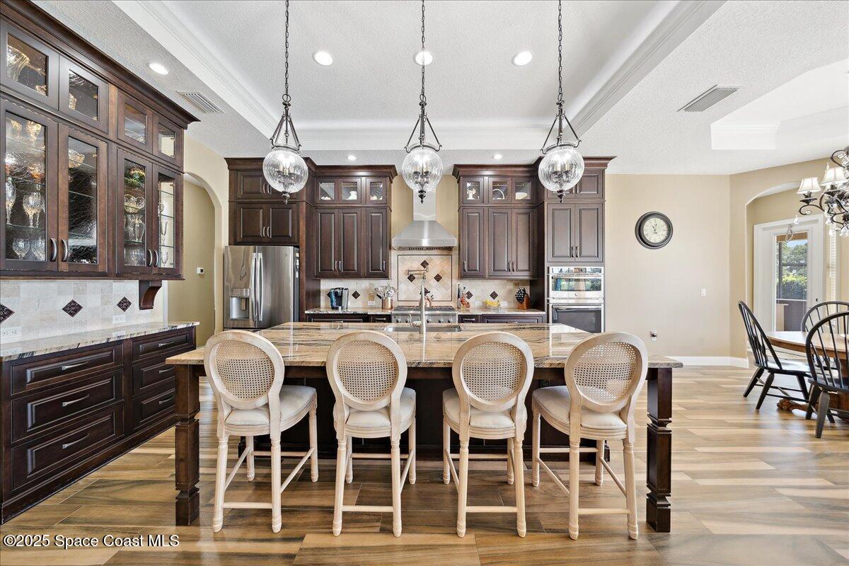 4464 Preservation Circle Melbourne, FL 32934 - Photo 8 of 65 a large kitchen with a table and chairs