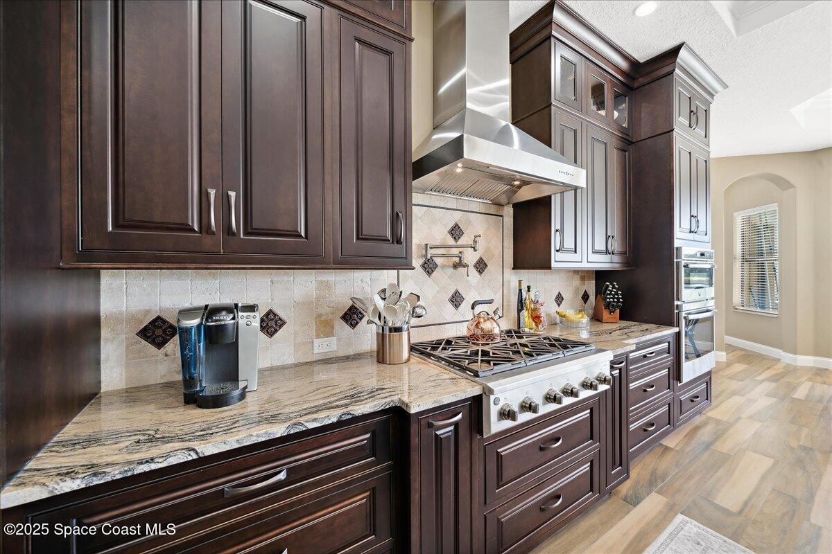 4464 Preservation Circle Melbourne, FL 32934 - Photo 10 of 65 a kitchen with stainless steel appliances granite countertop a stove and a sink