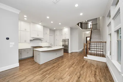 a kitchen with stainless steel appliances granite countertop a stove a sink and a refrigerator