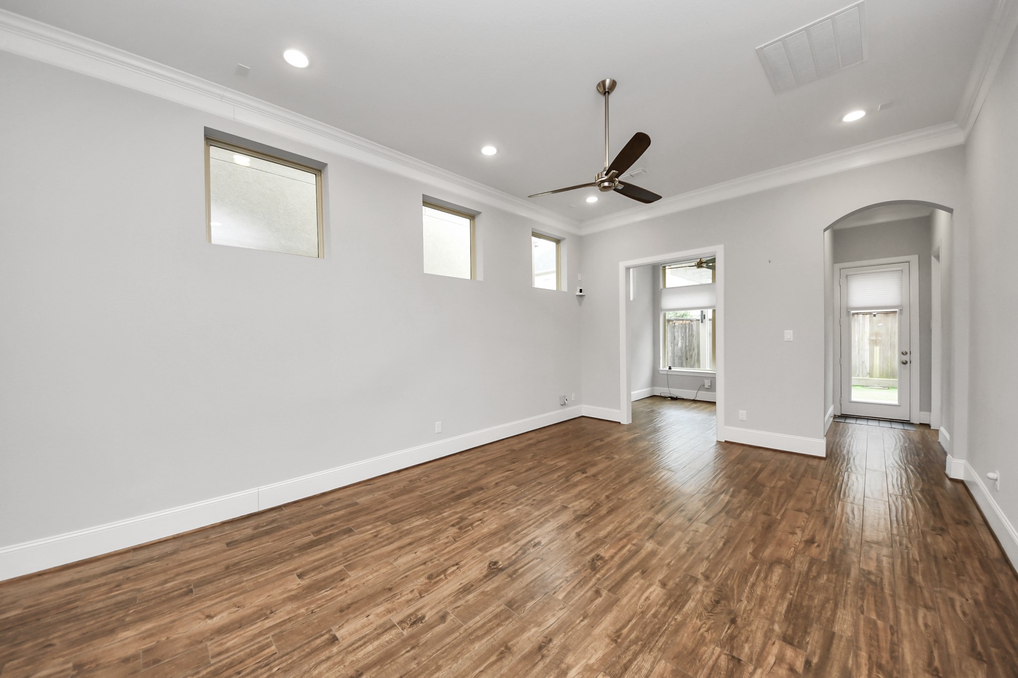 8609 Concord Trace Houston, TX 77055 - Photo 19 of 50 a view of an empty room with wooden floor and window