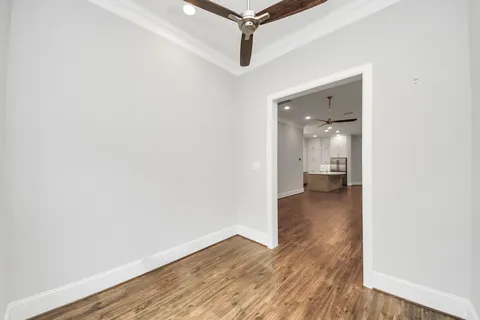 a view of a room with wooden floor and a bathroom
