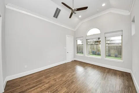 a bedroom with a large bed couch and a window