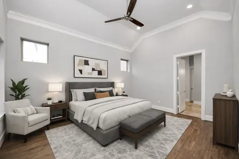 a bedroom with a large bed couch and a window