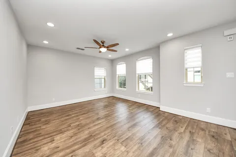 a view of a kitchen with a sink and wooden floor