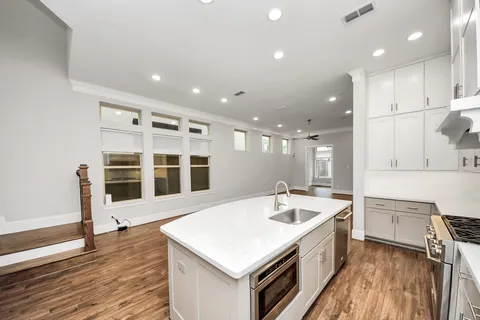 a kitchen with a stove a sink and a refrigerator