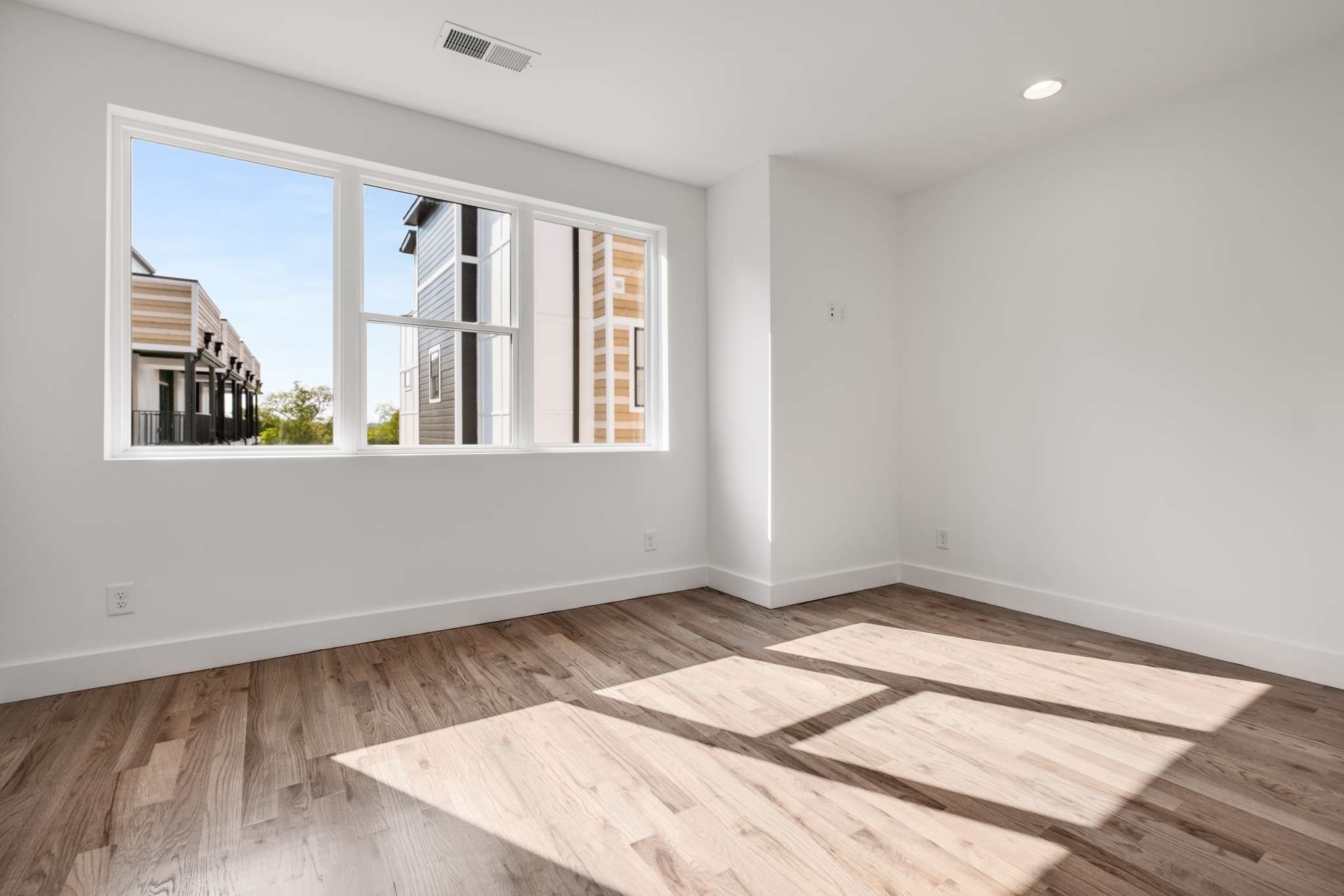 1806 Lischey Avenue, Unit 3 Nashville, TN 37207 - Photo 12 of 25 an empty room with wooden floor and windows