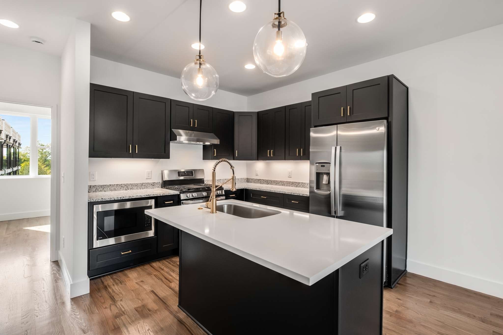 1806 Lischey Avenue, Unit 3 Nashville, TN 37207 - Photo 3 of 25 a kitchen with kitchen island granite countertop stainless steel appliances cabinets a sink and a center island