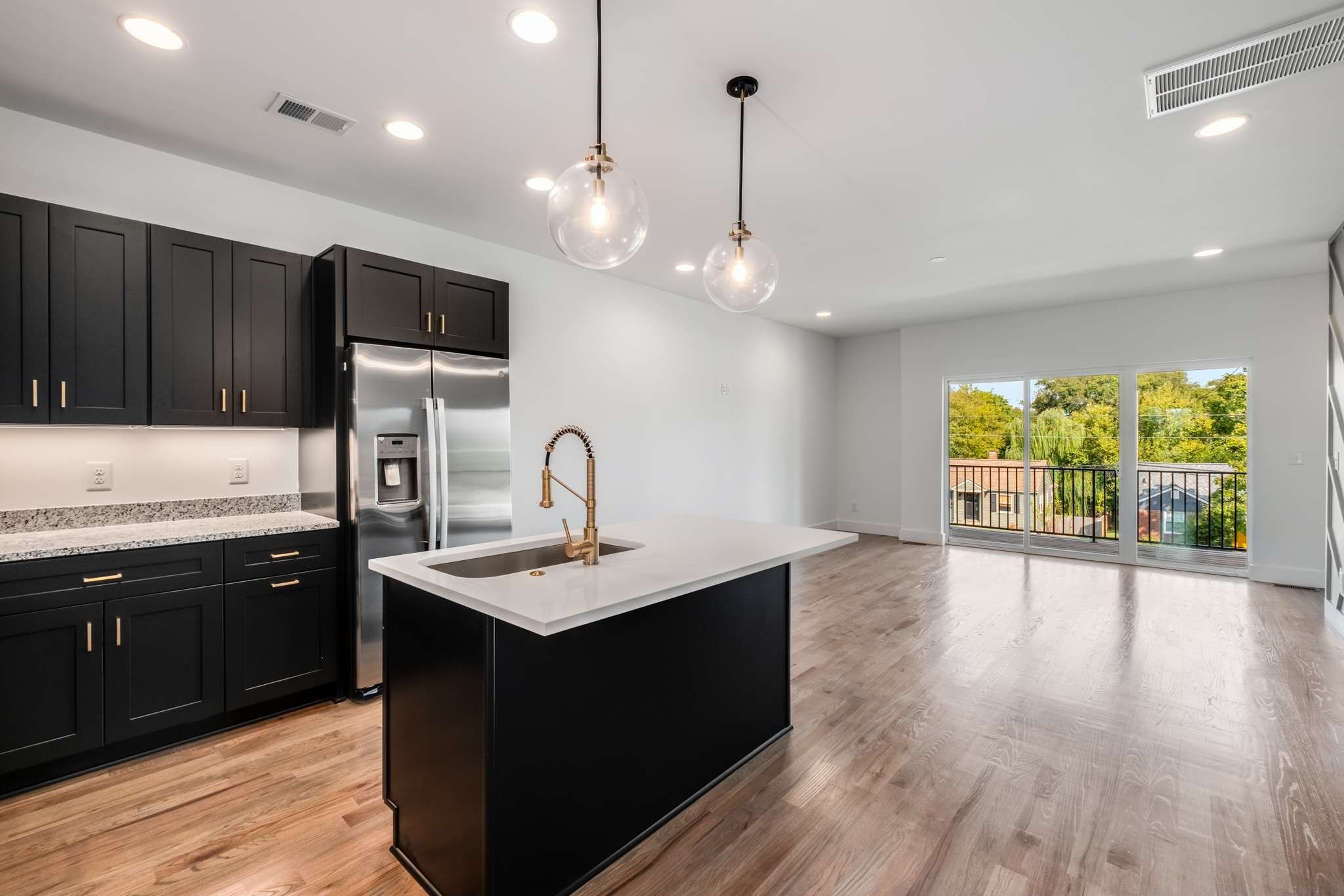 1806 Lischey Avenue, Unit 3 Nashville, TN 37207 - Photo 4 of 25 a kitchen with stainless steel appliances granite countertop a sink a stove and a wooden floors