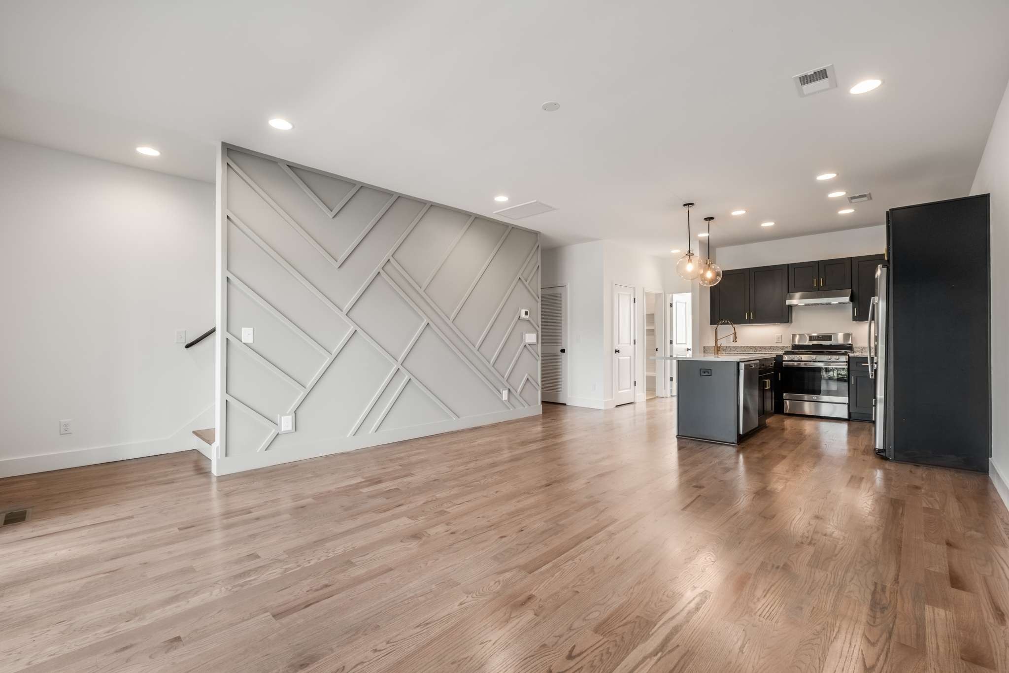1806 Lischey Avenue, Unit 3 Nashville, TN 37207 - Photo 7 of 25 an empty room with wooden floor and kitchen view