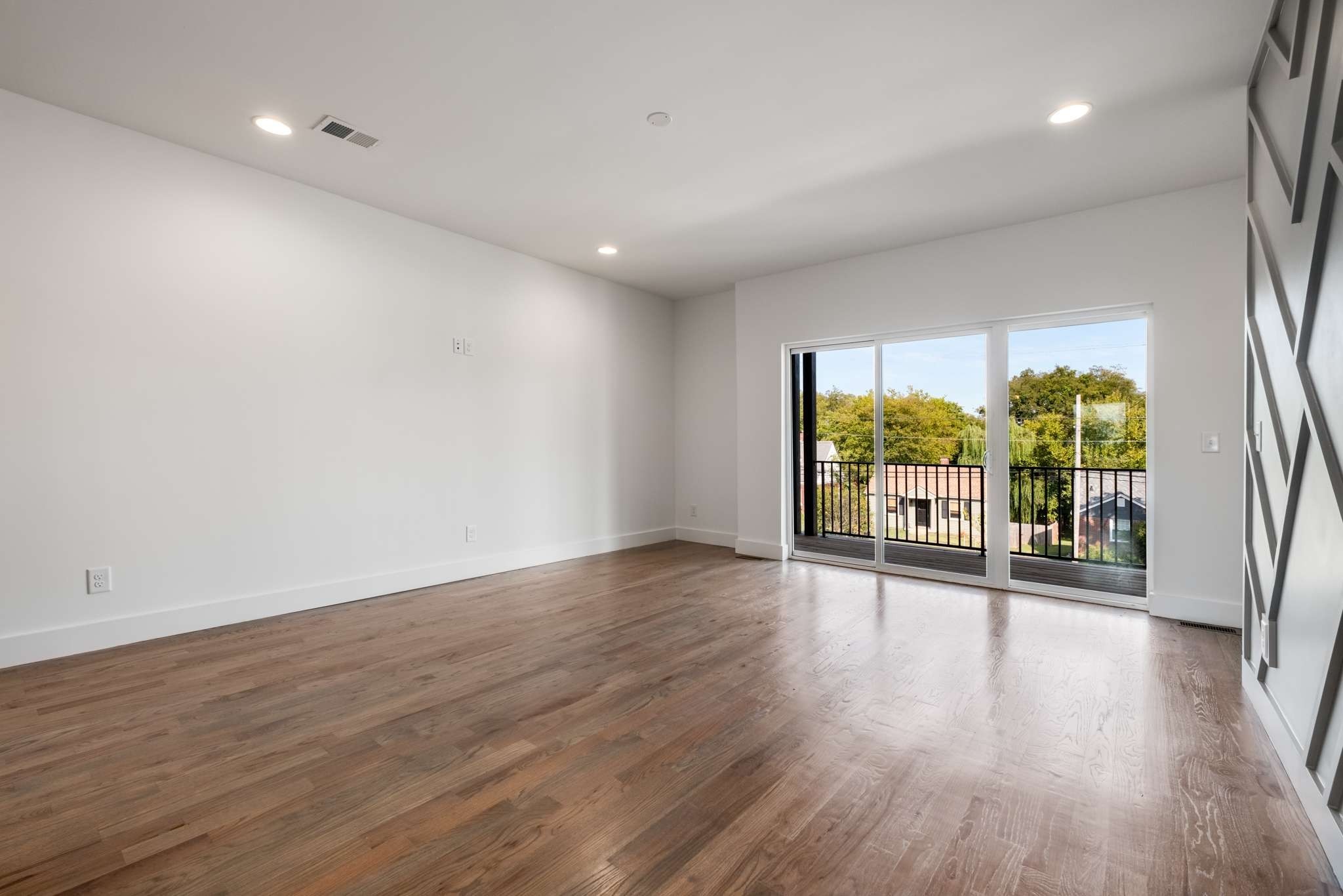 1806 Lischey Avenue, Unit 3 Nashville, TN 37207 - Photo 9 of 25 an empty room with wooden floor and windows
