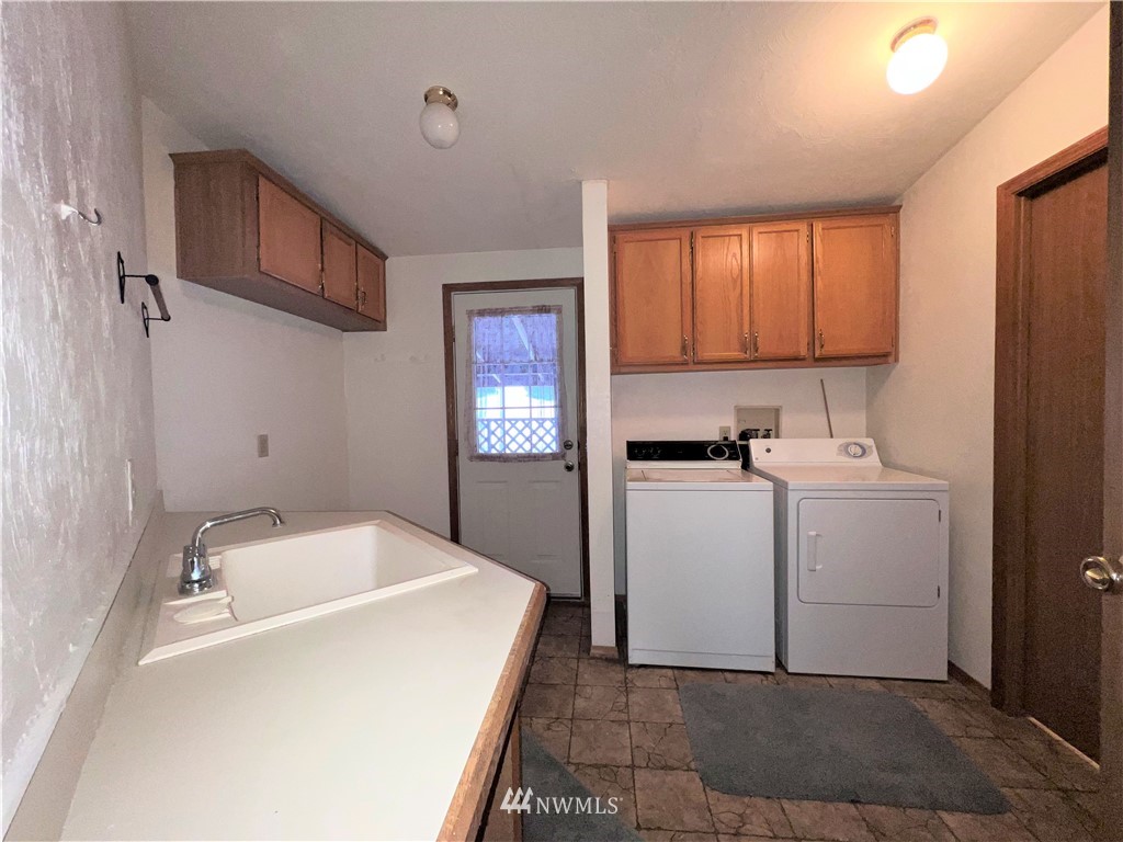 1009 Fir Loop Republic, WA 99166 - Photo 20 of 30 a utility room with cabinets washer and dryer