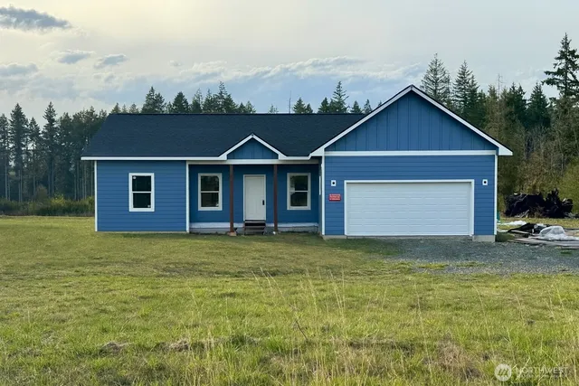 a view of a yard in front of a house with large trees