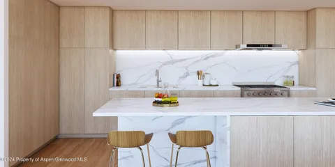 a kitchen with a sink cabinets and wooden floor