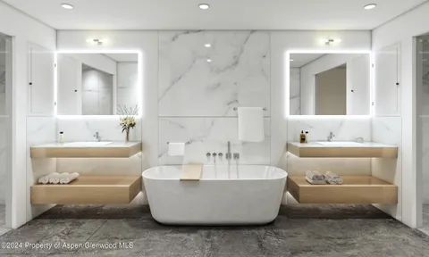 a bathroom with a white tub a sink and mirror