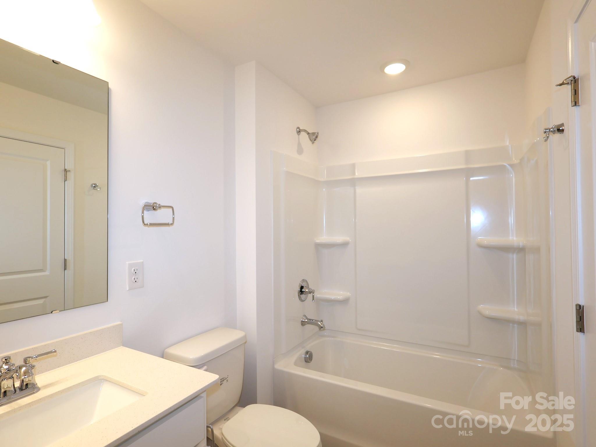 776 Kitfox Drive Northwest Concord, NC 28027 - Photo 9 of 12 a bathroom with a granite countertop bathtub shower sink vanity and toilet