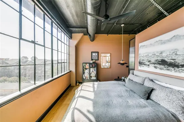 a bedroom with a bed next to a window