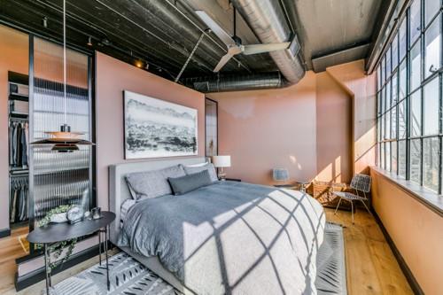 2220 Canton Street, Unit 406 Dallas, TX 75201 - Photo 12 of 22 a bedroom with a bed next to a window