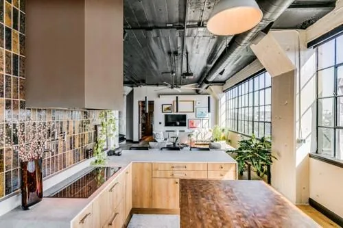 a kitchen with a stove a refrigerator a sink and dishwasher with wooden floor