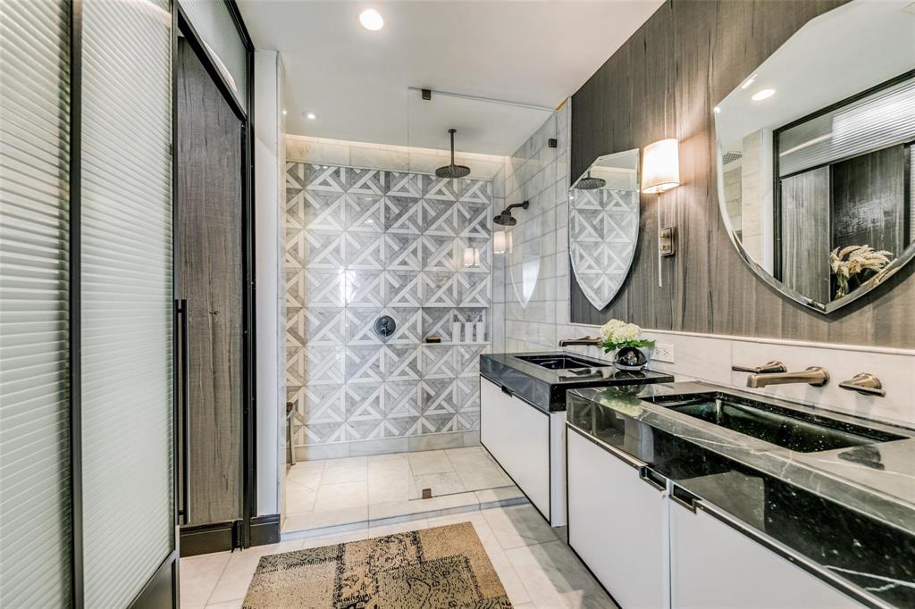 2220 Canton Street, Unit 406 Dallas, TX 75201 - Photo 10 of 22 a bathroom with a granite countertop sink a mirror a vanity and a shower