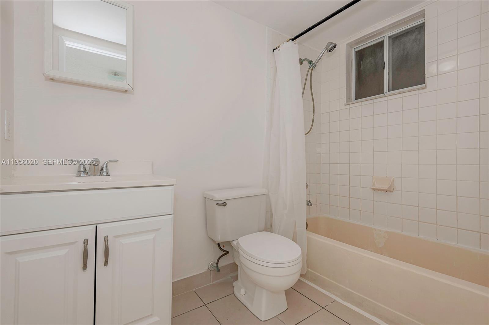 7785 West 30th Court, Unit F104 Hialeah, FL 33018 - Photo 12 of 17 a bathroom with a shower a toilet and sink