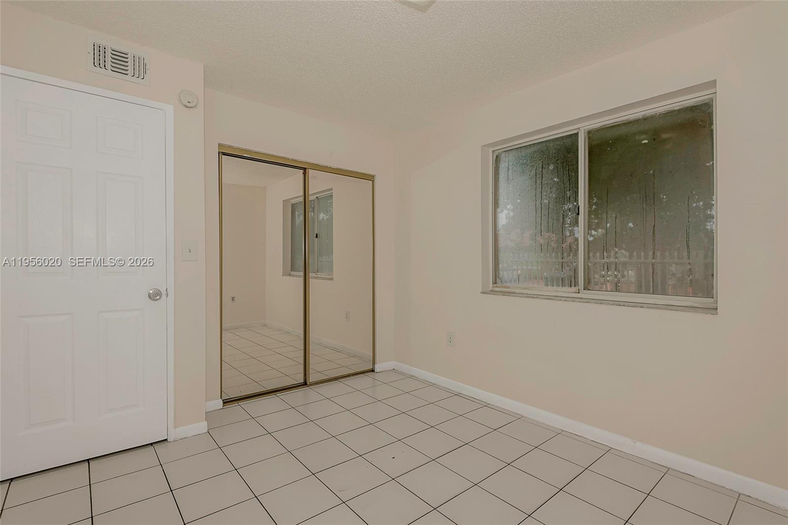 7785 West 30th Court, Unit F104 Hialeah, FL 33018 - Photo 14 of 17 a view of an empty room and window