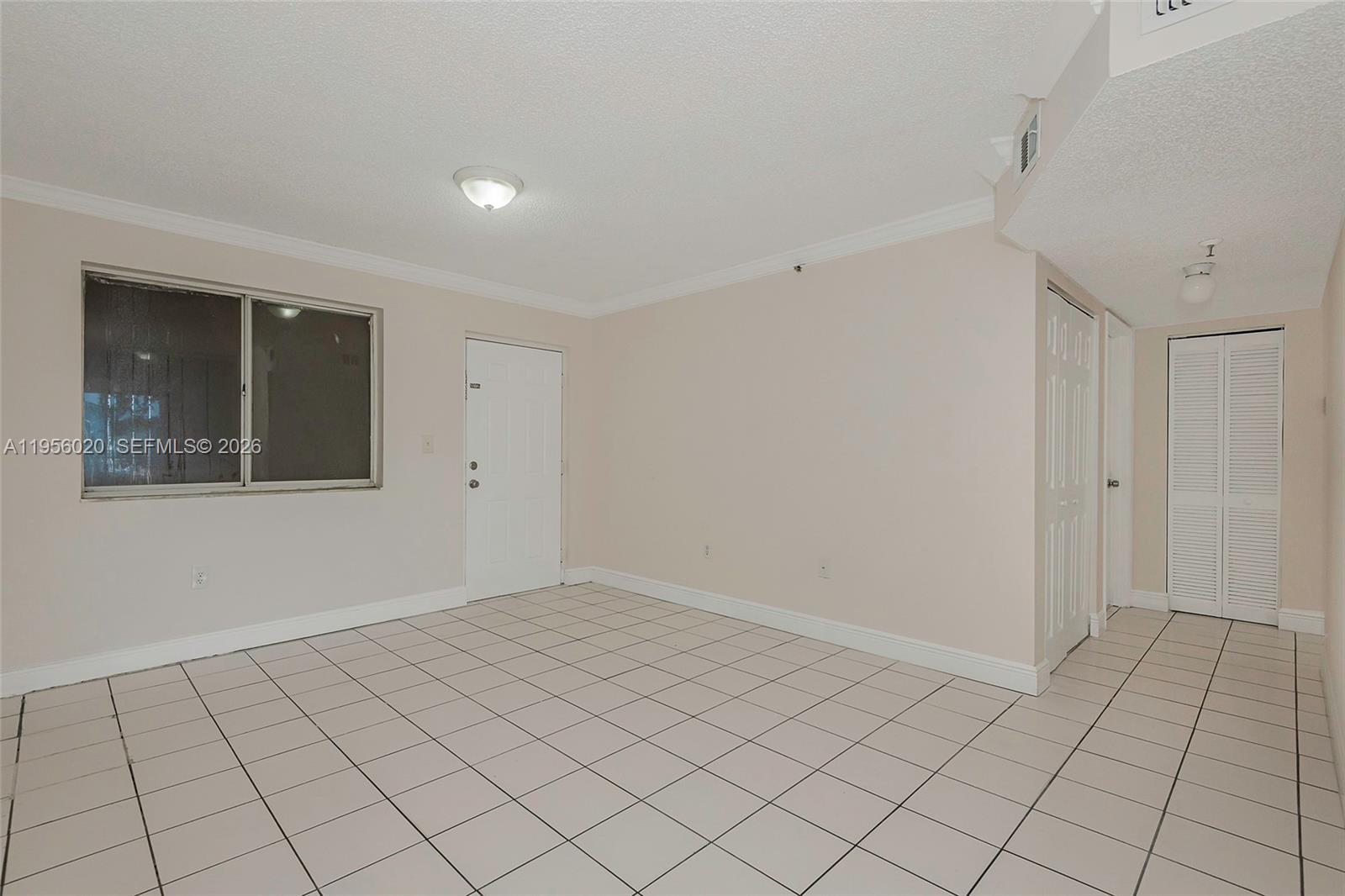 7785 West 30th Court, Unit F104 Hialeah, FL 33018 - Photo 7 of 17 a view of an empty room and window