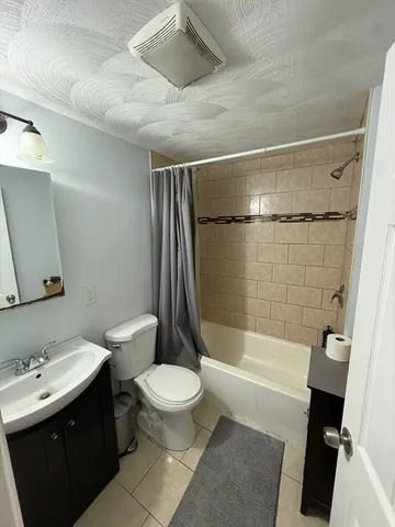 a bathroom with a toilet a sink and bathtub