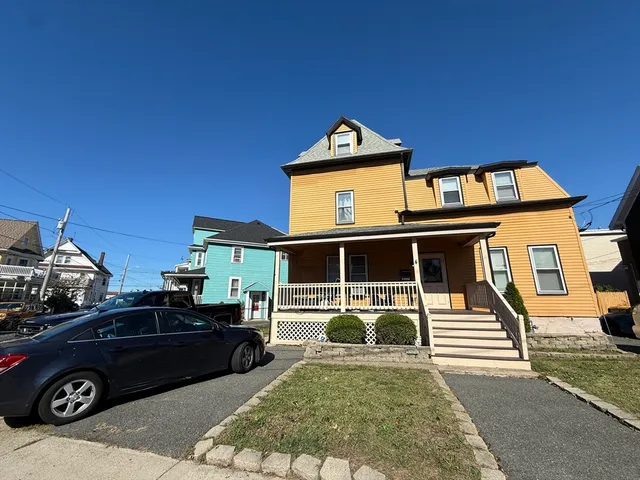a front view of a house with parking space