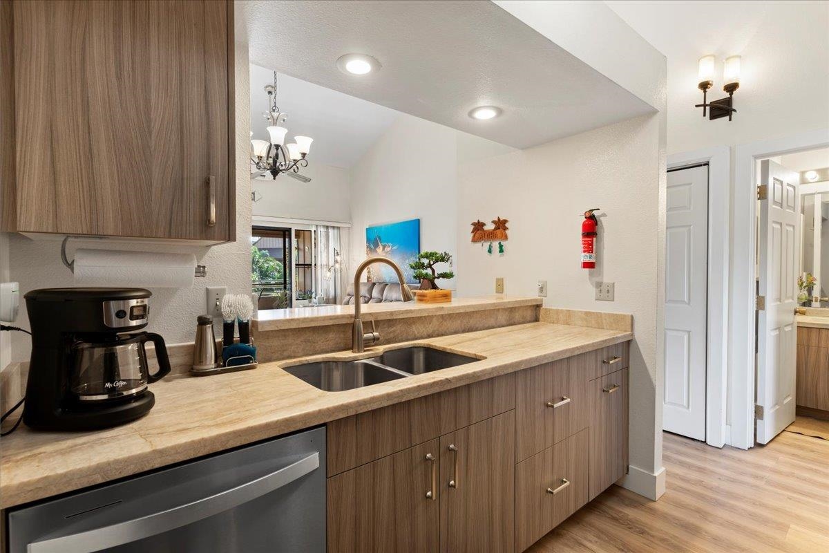679 South Kihei Road, Unit D203 Kihei, HI 96753 - Photo 18 of 46 a kitchen with a sink and cabinets