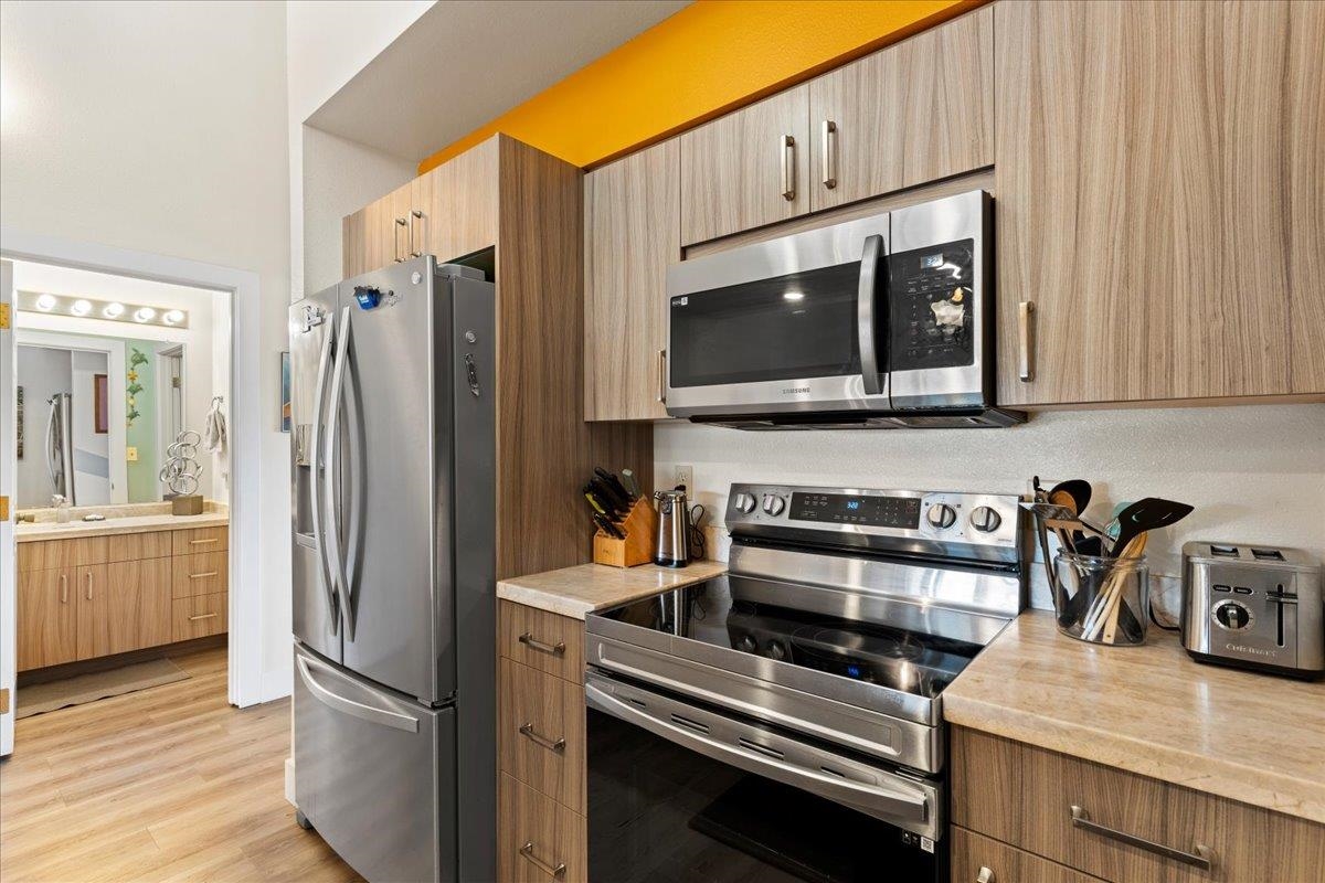 679 South Kihei Road, Unit D203 Kihei, HI 96753 - Photo 20 of 46 a kitchen with stainless steel appliances a refrigerator stove and microwave