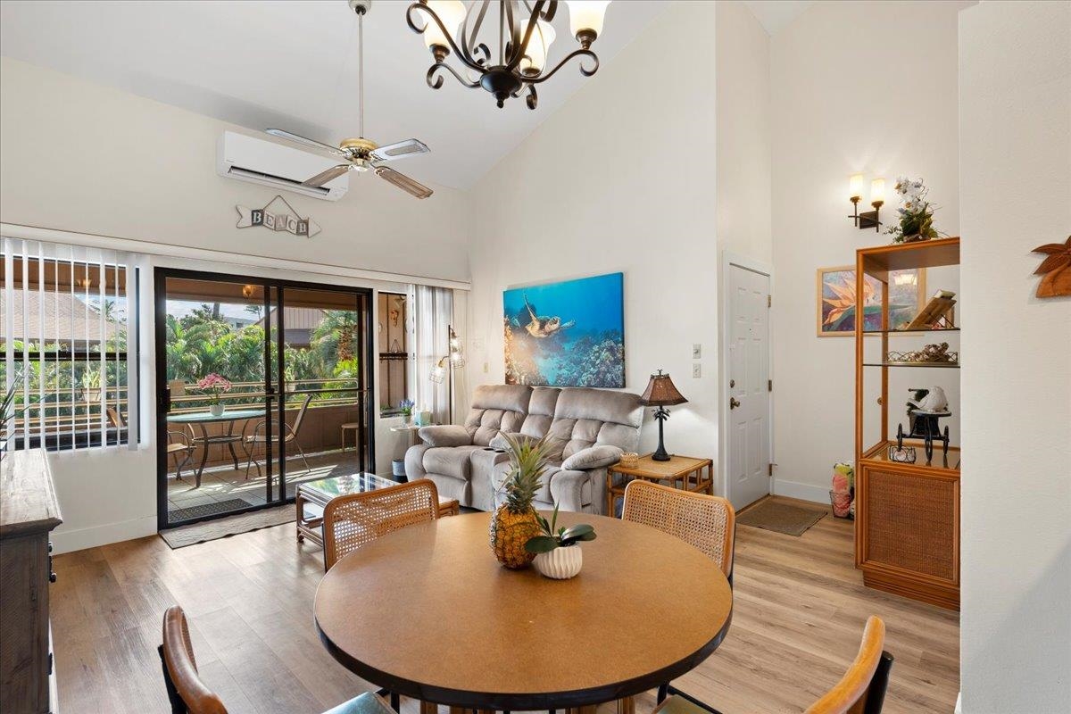 679 South Kihei Road, Unit D203 Kihei, HI 96753 - Photo 26 of 46 a living room with furniture a large window and wooden floor