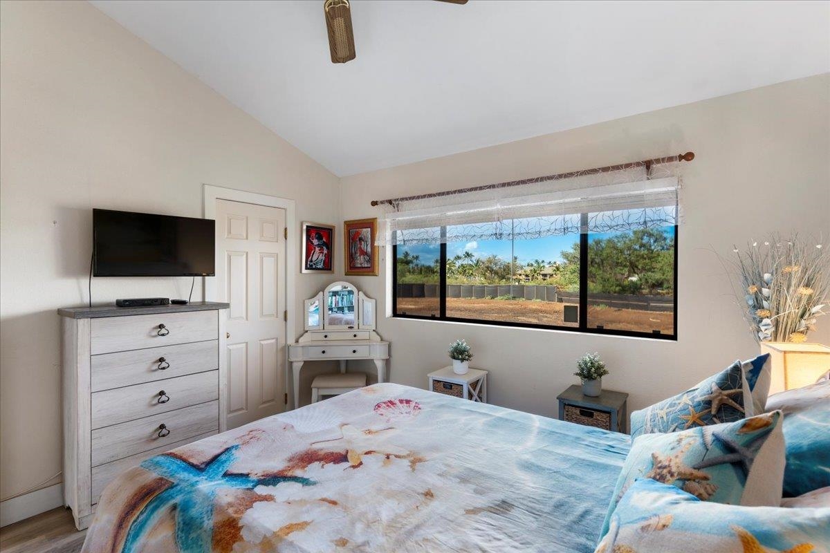 679 South Kihei Road, Unit D203 Kihei, HI 96753 - Photo 38 of 46 a bedroom with a bed and a flat tv screen on dresser