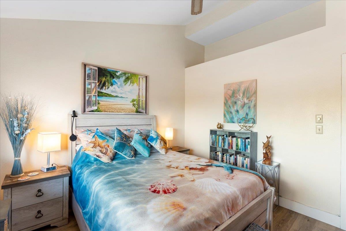 679 South Kihei Road, Unit D203 Kihei, HI 96753 - Photo 39 of 46 a bedroom with a bed and a table in it